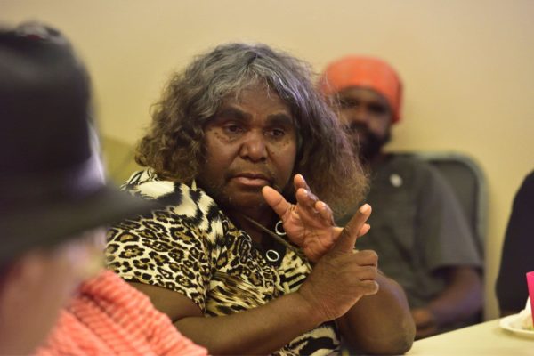 An old female Aboriginal Australian pointing out something